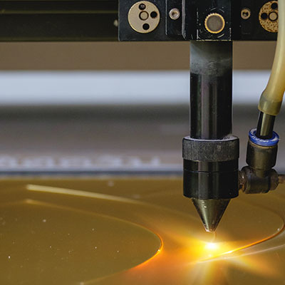 Laser cutter in acrylic award manufacturing facility.
